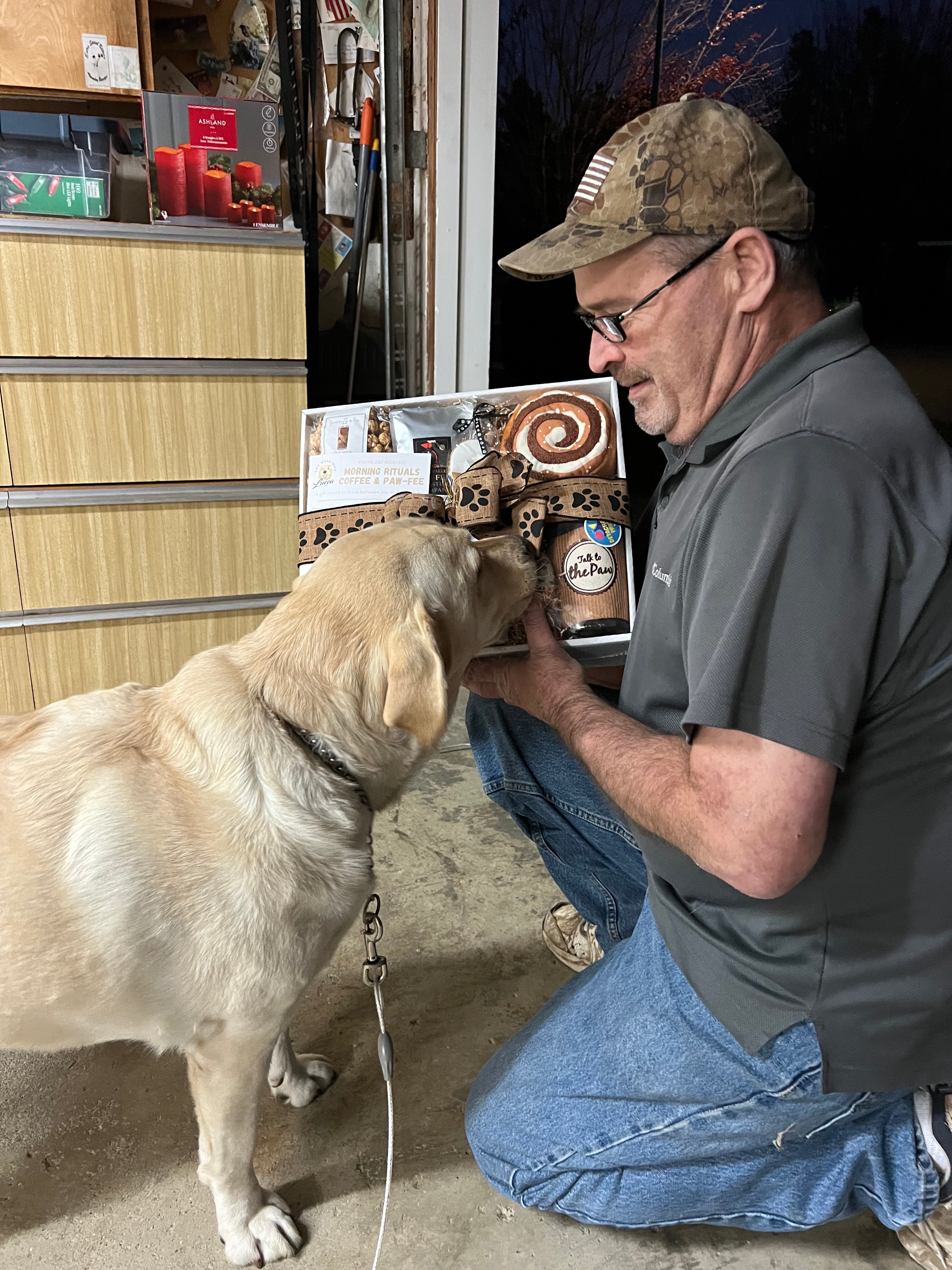 man sharing a gift basket with his dog